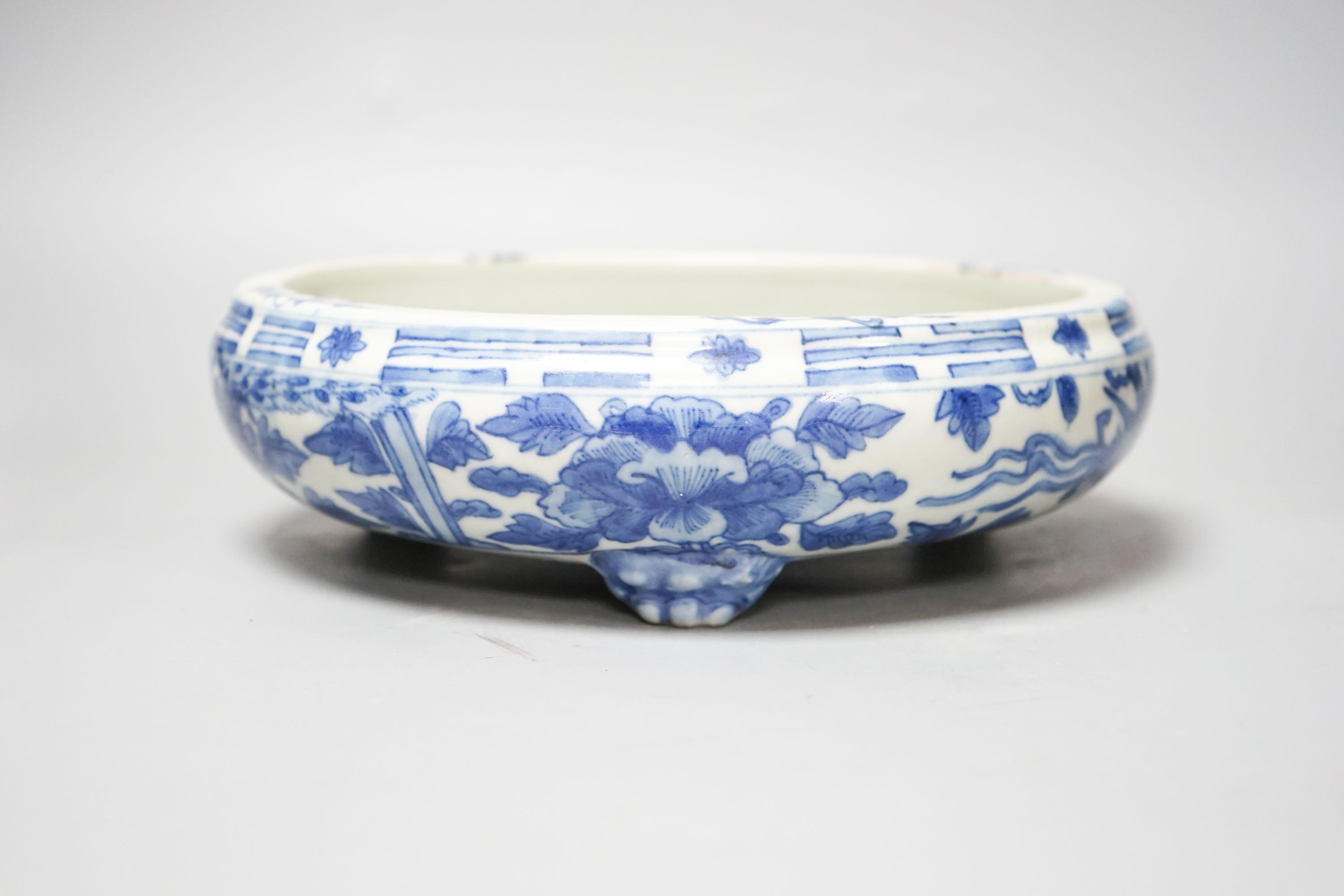 A 19th century Chinese circular blue and white censer, with phoenix and peony decoration, on three lion's paw feet 26cm